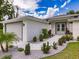 Welcoming single-story home with a gray brick walkway and beautifully landscaped front garden at 17130 Elder St, Port Charlotte, FL 33954