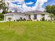 An attractive single-Gathering home featuring a spacious lawn and nicely landscaped front yard at 17130 Elder St, Port Charlotte, FL 33954