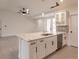 Open kitchen with stainless steel appliances, island with seating, and modern cabinetry at 17130 Elder St, Port Charlotte, FL 33954