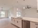 Bright kitchen showcasing an island with a sink, stainless steel appliances, and modern lighting at 17130 Elder St, Port Charlotte, FL 33954