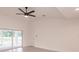 Bright living room featuring a ceiling fan, large sliding doors, and neutral wall color at 17130 Elder St, Port Charlotte, FL 33954