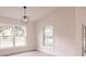 Living room with large windows offering a view of the outdoors and modern light fixture at 17130 Elder St, Port Charlotte, FL 33954
