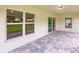 Covered back patio featuring neutral tile, a ceiling light, and view to the exterior at 17130 Elder St, Port Charlotte, FL 33954