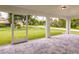 Covered back patio featuring neutral tile and a view to the grassy lawn at 17130 Elder St, Port Charlotte, FL 33954