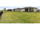 Sprawling green backyard with black metal fencing, ideal for outdoor activities and privacy at 1734 Saddlewood Cir, Port Charlotte, FL 33953