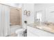 Elegant bathroom featuring a shower-tub combo, granite countertop vanity, toilet, and decorative accents at 1734 Saddlewood Cir, Port Charlotte, FL 33953