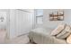 Bright bedroom featuring a bed with white pillows, a window with blinds, and a closet with white doors at 1734 Saddlewood Cir, Port Charlotte, FL 33953