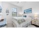 Well-lit bedroom featuring a comfortable bed, side tables with lamps, decorative wall art, and a dresser at 1734 Saddlewood Cir, Port Charlotte, FL 33953