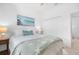 Cozy bedroom featuring a plush bed with decorative pillows and a soft blanket, complemented by a side table with a lamp at 1734 Saddlewood Cir, Port Charlotte, FL 33953