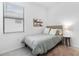 Bright bedroom featuring a comfortable bed, stylish side table with lamp, and coastal-themed wall decor at 1734 Saddlewood Cir, Port Charlotte, FL 33953