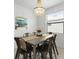 Elegant dining room featuring modern chandelier and beach-themed artwork at 1734 Saddlewood Cir, Port Charlotte, FL 33953