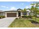 Charming single-story home with a well-maintained lawn and lush landscaping at 1734 Saddlewood Cir, Port Charlotte, FL 33953