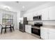 Clean white kitchen featuring stainless steel appliances and tile flooring at 1734 Saddlewood Cir, Port Charlotte, FL 33953