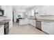 Spacious kitchen with stainless appliances, stone counters and dining area at 1734 Saddlewood Cir, Port Charlotte, FL 33953