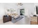 Bright living room featuring neutral decor, tile flooring, and outdoor access at 1734 Saddlewood Cir, Port Charlotte, FL 33953