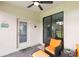 Cozy outdoor patio space featuring comfortable seating, a ceiling fan, and easy access to the backyard at 1734 Saddlewood Cir, Port Charlotte, FL 33953
