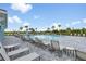Resort-style pool area with ample lounge chairs and shaded umbrellas for relaxation at 1734 Saddlewood Cir, Port Charlotte, FL 33953