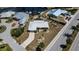 An aerial view of the house shows its waterfront location with a canal behind and a clean, well-maintained yard at 190 Casa Ln, Punta Gorda, FL 33950
