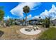 Spacious backyard with a concrete picnic table, palm trees, and view of the canal at 190 Casa Ln, Punta Gorda, FL 33950