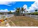 Backyard with white picket fence and sparse lawn in residential neighborhood at 190 Casa Ln, Punta Gorda, FL 33950