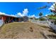 Fenced backyard includes screened lanai, tropical plants and some lawn at 190 Casa Ln, Punta Gorda, FL 33950