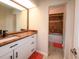 This bathroom has granite countertops, white cabinets, a mirror and access to the tub and shower at 190 Casa Ln, Punta Gorda, FL 33950