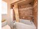 The bathroom contains a tub/shower combination with a curtain, tile surround and a toilet at 190 Casa Ln, Punta Gorda, FL 33950