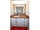 The bathroom has granite countertops, white cabinets, a mirror, sink, and modern black fixtures at 190 Casa Ln, Punta Gorda, FL 33950