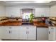 Bright kitchen showcasing white cabinets, granite countertops, and a stainless steel dishwasher at 190 Casa Ln, Punta Gorda, FL 33950