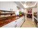 Kitchen featuring granite countertops, white cabinets, and stainless steel appliances at 190 Casa Ln, Punta Gorda, FL 33950