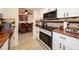 Modern kitchen with white cabinets, tile backsplash, stainless steel appliances, and granite countertops at 190 Casa Ln, Punta Gorda, FL 33950