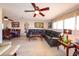 Inviting living room with a large leather sofa, decorative furnishings, tile flooring and a ceiling fan at 190 Casa Ln, Punta Gorda, FL 33950