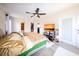 This main bedroom has a ceiling fan, tv, tile floor, ensuite bathroom, and walk-in closet at 190 Casa Ln, Punta Gorda, FL 33950