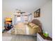 Bright main bedroom featuring a ceiling fan, wood floors, a decorative headboard, and natural light at 190 Casa Ln, Punta Gorda, FL 33950