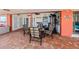 Spacious patio featuring brick flooring, a dining table, and a seating area at 190 Casa Ln, Punta Gorda, FL 33950