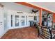 Inviting covered patio with brick flooring, ceiling fan, and comfortable seating area at 190 Casa Ln, Punta Gorda, FL 33950