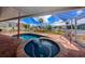 Stunning screened-in pool area with an attached hot tub and brick patio at 190 Casa Ln, Punta Gorda, FL 33950