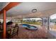 Relaxing screened-in patio with a pool, hot tub, and outdoor seating at 190 Casa Ln, Punta Gorda, FL 33950