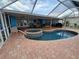 Outdoor pool and hot tub combo surrounded by a screened enclosure, offering a private backyard oasis at 190 Casa Ln, Punta Gorda, FL 33950