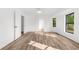 A bedroom with light wood flooring, white walls, and a window with natural light at 19723 Midway Blvd, Port Charlotte, FL 33948