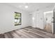 Bright bedroom with wood floors, closet, and natural light from a large window at 19723 Midway Blvd, Port Charlotte, FL 33948