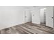 Bedroom with gray wood floors, closet and ensuite bathroom at 19723 Midway Blvd, Port Charlotte, FL 33948