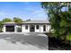 Charming home with a metal roof, freshly painted white exterior, and a detached garage at 19723 Midway Blvd, Port Charlotte, FL 33948