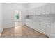 Bright kitchen features white cabinets with gold hardware, marble countertops, and tile floors at 19723 Midway Blvd, Port Charlotte, FL 33948