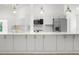 An open white kitchen with stainless steel appliances and bright natural light at 19723 Midway Blvd, Port Charlotte, FL 33948
