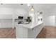 Modern kitchen boasts an expansive island with marble countertops and updated appliances at 19723 Midway Blvd, Port Charlotte, FL 33948