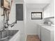 Convenient laundry room featuring a sink, modern washer and dryer, and updated fixtures at 19723 Midway Blvd, Port Charlotte, FL 33948