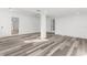 Bright, open living room featuring gray wood floors and recessed lighting at 19723 Midway Blvd, Port Charlotte, FL 33948
