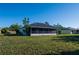 The backyard features a screened-in lanai and lush green lawn, perfect for outdoor relaxation at 2271 Alton Rd, Port Charlotte, FL 33952