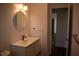 Modern bathroom with sleek vanity, round mirror, and contemporary fixtures at 2271 Alton Rd, Port Charlotte, FL 33952